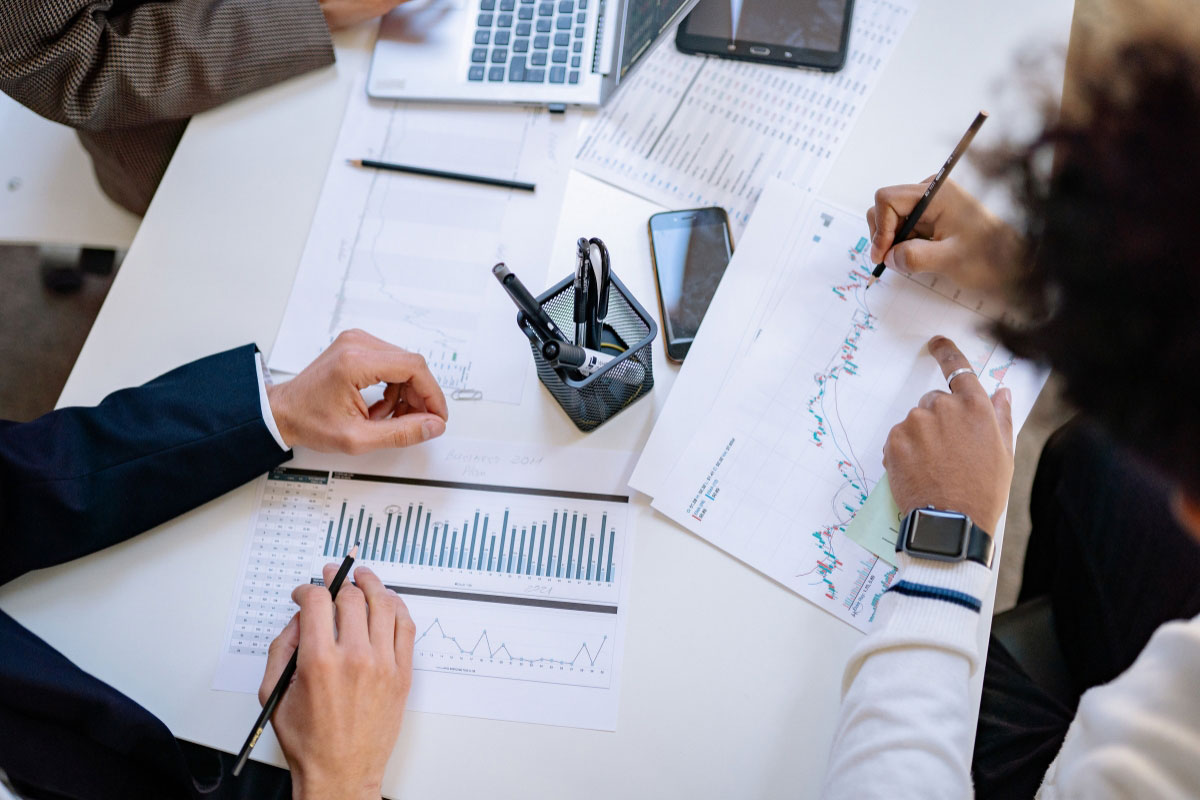 Business team analyzing rollout performance data and infrastructure cost metrics
