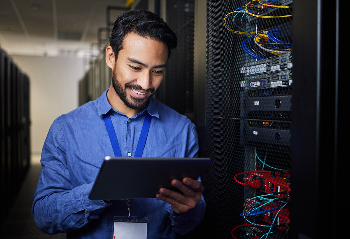 it technician monitors system progress on tablet
