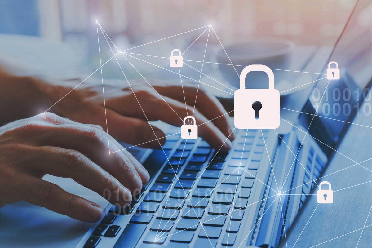 Hands typing on laptop with digital lock and network overlays representing secure access control across connected locations.