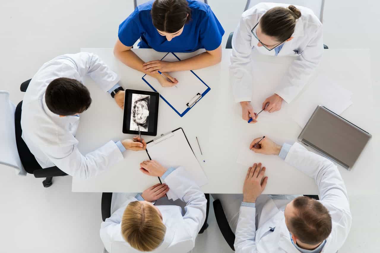 Dental team with synchronized technology sitting around a table